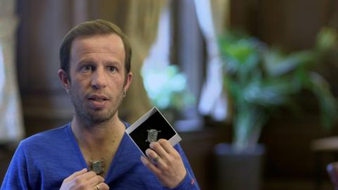 Liviu Babitz shows a device attached to his chest