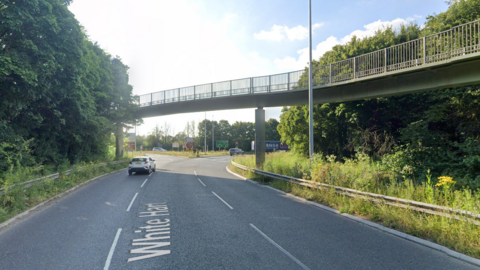 The A419 leading up to the White Hart junction. There are three lanes and a bridge going over the road.