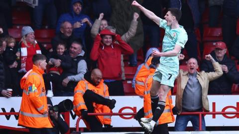 Joe Cotterill jumps and punches the air in celebration at scoring for Swindon at Walsall