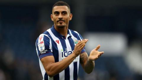 Karlan Grant claps the fans at the end of a game for West Brom