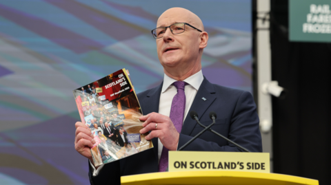 Man holds manifesto at podium