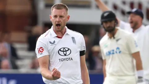 England bowler Gus Atkinson celebrates taking a wicket