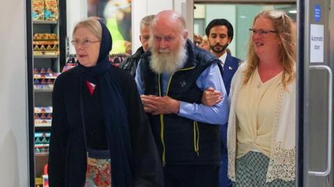 A photo of Jonathan and Barbie Reynolds with their daughter Sarah Entwistle at Heathrow Airport