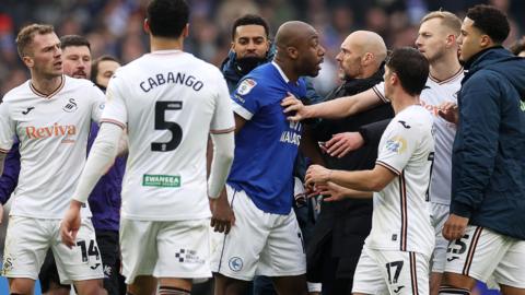 Players and staff from Cardiff and Swansea clash after full time 