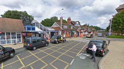 Google Street View of Farnborough Main train station with the taxi rank in the foreground. Three black cabs and a people carrier are parked outside the brick station building with a pitched roof.