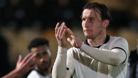 Ruari Paton claps the crowd after a game for Port Vale 