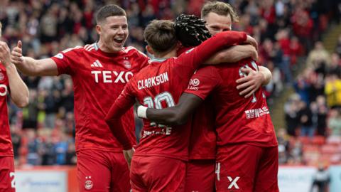 Aberdeen's Kevin Nisbet celebrates with teammates after Pape Habib Gueye scores to make it 1-0 during a Premier Sports Cup quarter-final match between Aberdeen and The Spartans at Pittodrie, 