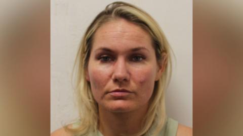 A custody image of a blonde woman.