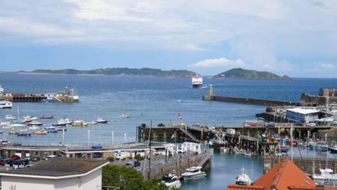 View of St Peter Port harbour in Guernsey with a ferry arriving.