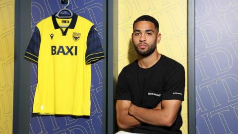 Brodie Spencer poses for a photo after signing with Oxford United 
