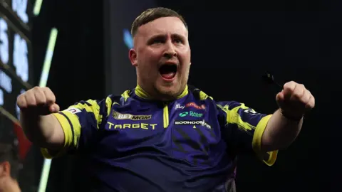 Luke Littler celebrates