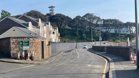 A car drives down the section of road which had been closed