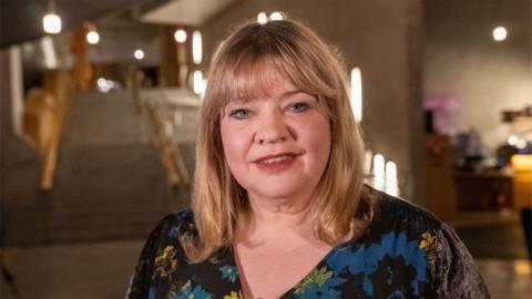 The BBC's Kirsten Campbell stands in the Garden Lobby of the Scottish Parliament.