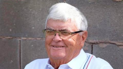 Photo of David Edward Roberts, an elderly man with white hair. He is wearing glasses and smiling and wearing a white shirt.