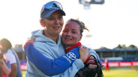 Danni Wyatt-Hodge is hugged by Charlotte Edwards