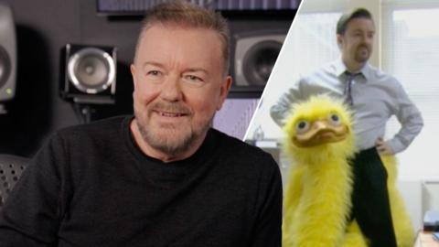 Ricky Gervais smiles at the camera. Behind him is an image of him as David Brent dressed in an ostrich costume