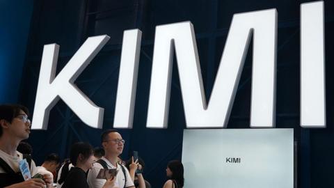 Visitors at a trade show in Shanghai visit a booth with the Kimi sign displayed in large block letters  