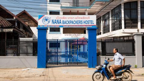 A motorcyclist passes the Nana Backpackers Hostel in Vang Vieng on November 24, 2024. 