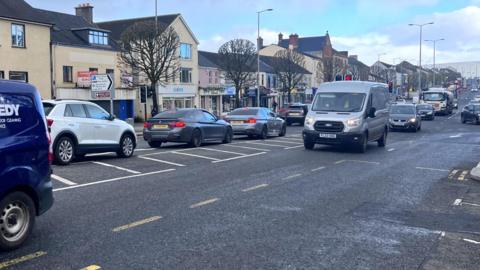 A view of the main street in Cookstown with heavy traffic driving through