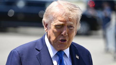 US President Donald Trump speaks to reporters before boarding Air Force One in Palm Beach, Florida.
