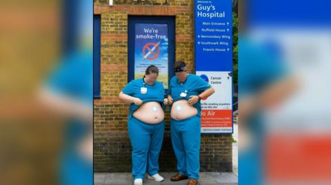 A screen grab of a promotional video showing two doctors in scrubs, outside Guy's hospital placing weight loss patches on their stomachs 