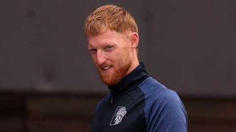 Ben Stokes in a navy blue Durham tracksuit top