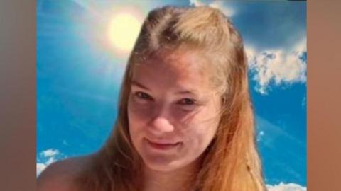 Orinata Narbutaite is pictured. She has long light brown hair. She is wearing a summer dress patterned with flowers.