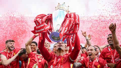 Liverpool captain Virgil van Dijk lifts the Premier League trophy 
