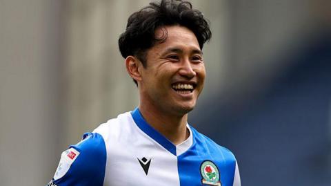 A smiling Ryoya Morishita during a match for Blackburn in a home shirt