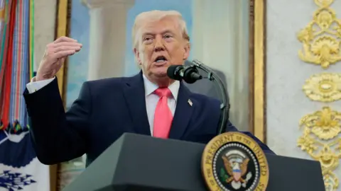 Donald Trump speaks from a lectern.