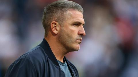 Ryan Lowe watching Preston play in his final match in charge in August