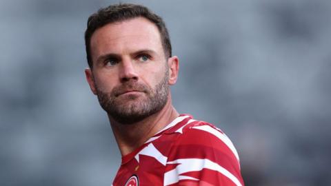 Juan Mata wearing a red and white T-shirt