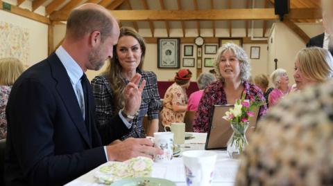 The Prince and Princess of Wales speak to members during a visit to the National Federation of Women's Institute (WI) in Sunningdale, Berkshire, to mark the third anniversary Queen Elizabeth II's death