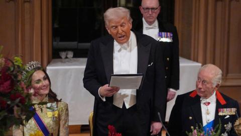 US President Donald Trump delivers his speech as King Charles III and the Princess of Wales listen beside him