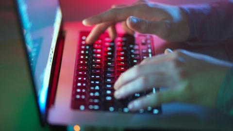 Anonymous shot of a person's hand typing in a keyboard.