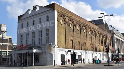 The Old Vic theatre - a large brick building which as a canopy held up by columns on the front. The Old Vic is written across the face of the building