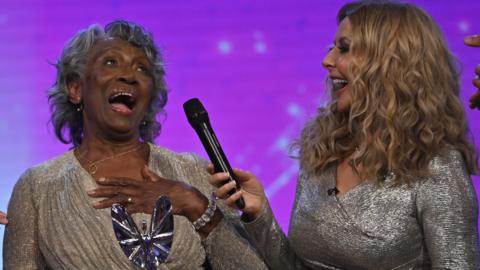 Agnes Nisbett (left) on stage with Carol Vorderman at the Pride of Britain awards