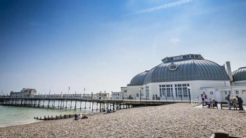 A large white building on the beach. 