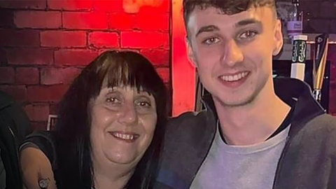 Jay Slater smiles at the camera with his arm around the shoulders of his mum, Debbie Duncan