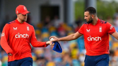 Liam Livingstone (left) gets handed the ball by Saqib Mahmood during a white-ball match for England