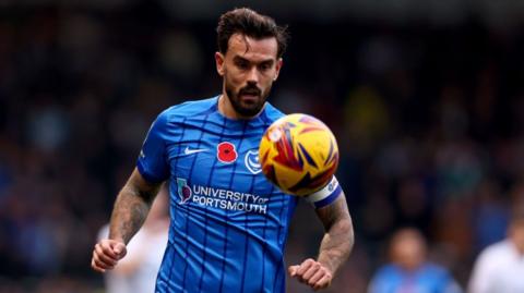 Marlon Pack of Portsmouth looking at a football in the air