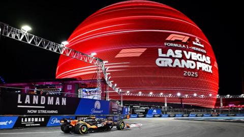 McLaren's Lando Norris passes the illuminated sphere during first practice for the Las Vegas Grand Prix