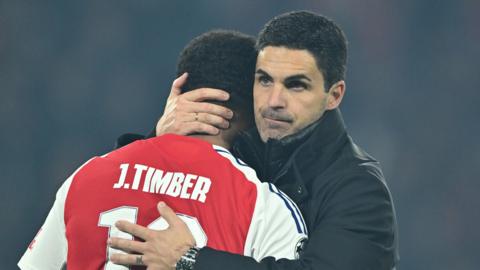 Arsenal manager Mikel Arteta hugs defender Jurrien Timber after their Champions League semi-final loss at Paris St-Germain