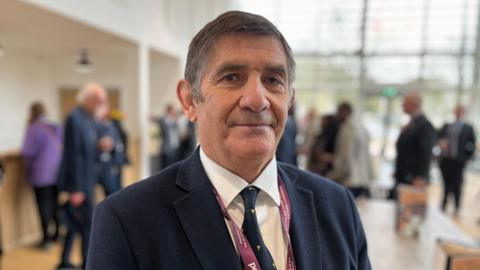 Wiltshire Police and Crime Commissioner Philip Wilkinson pictured wearing a navy suit and smiling