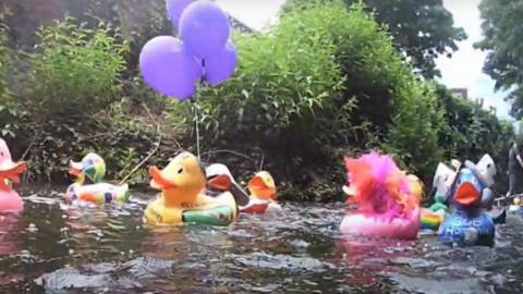 Decorated ducks on a river