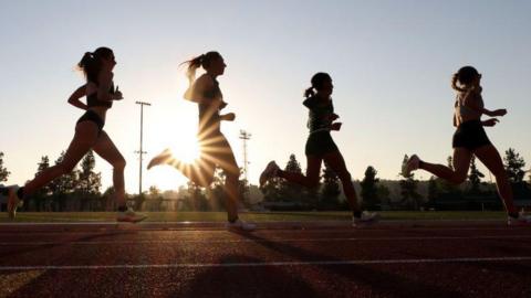 Image of anonymous runners competing in a 5,000m race