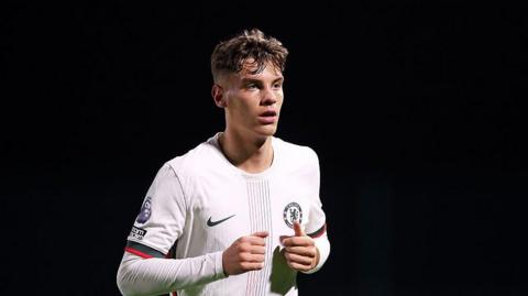 Ollie Harrison jogs along in a white Chelsea Under-21 shirt against Everton Under-21s last October