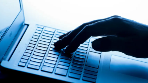 A general view of hand on a laptop keyboard