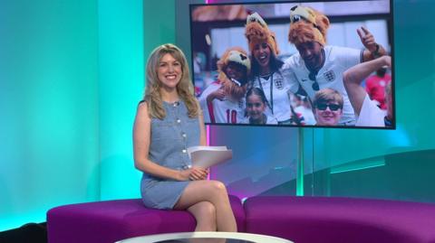 Jenny in the studio with England fans in the screen