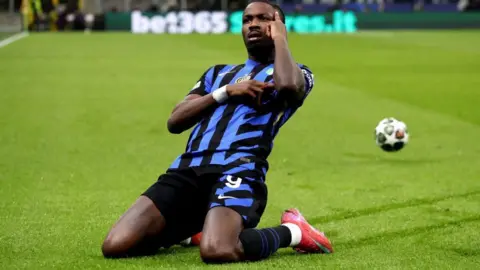 Marcus Thuram celebrates scoring for Inter in the Champions League